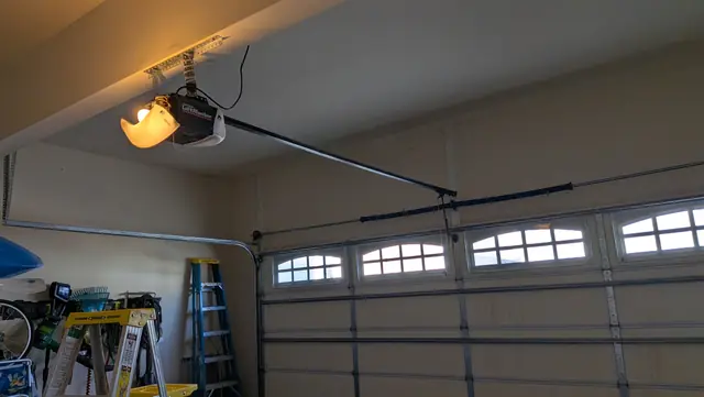 Garage door with arched windows and a newly mounted opener