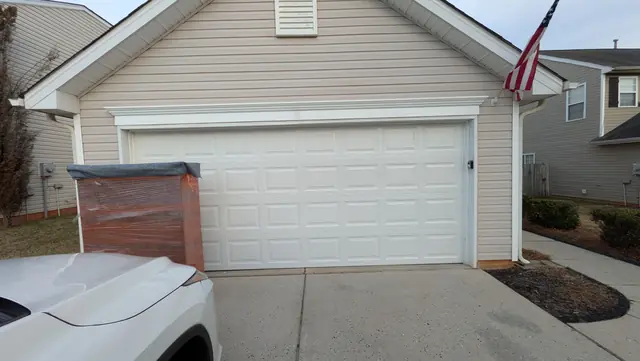White raised-panel garage door on a North Carolina home